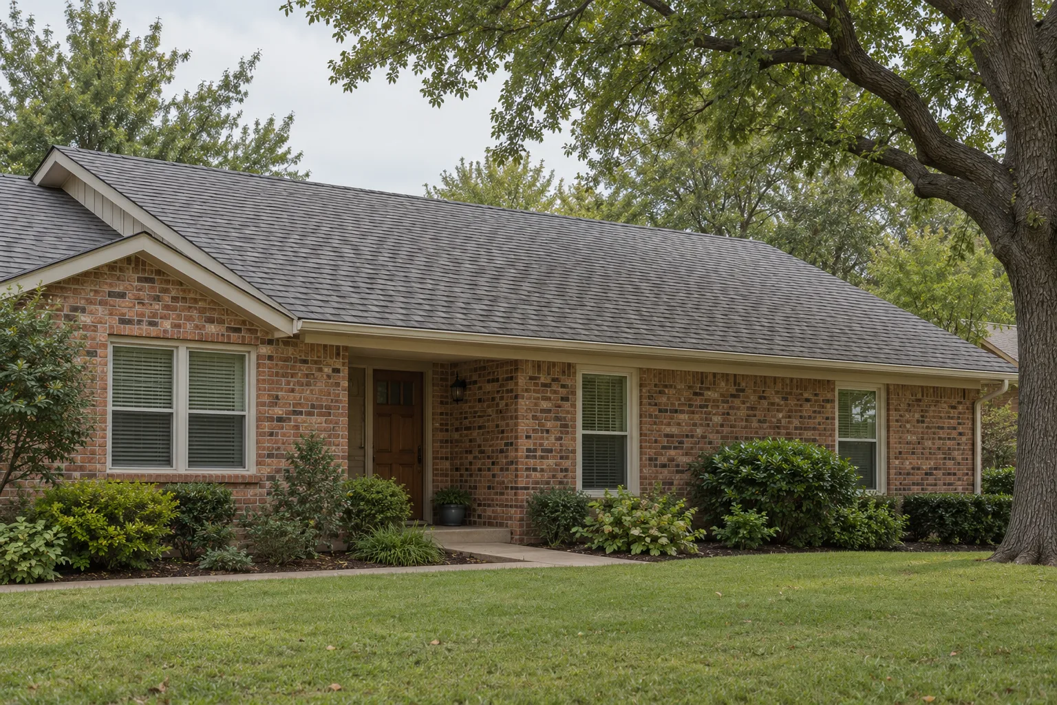 Illustrative established brick ranch with a gray shingle roof and front garden